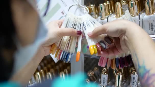 Asian Woman Browsing Choosing Nail Colors Shop — Vídeo de Stock