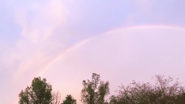 Full Vivid Rainbow Fills Pink Sky Overhead Storm Slow Pan — 图库视频影像