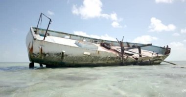 Abandoned Rusty Shipwreck With Calm Ocean Waves In Bahamas. - wide shot