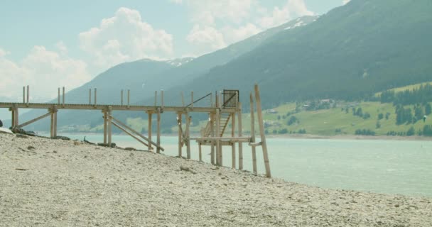 Wooden Bridge Shore Reschensee Italy People Kite Boarding Sunny Day — Stock Video