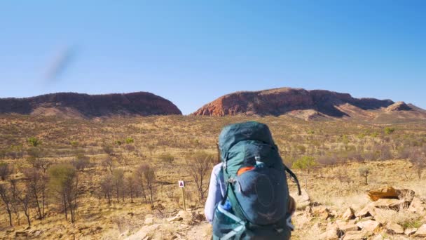 Hiker Walks Open Landscape Distant Rock Formations Australia — Stock Video