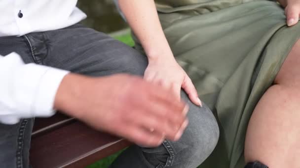 Man Places Hand Top Woman Hand While Sitting Bench — Vídeos de Stock