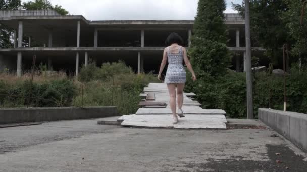 Unrecognizable Woman Enters Abandoned Water Park Static View — Video