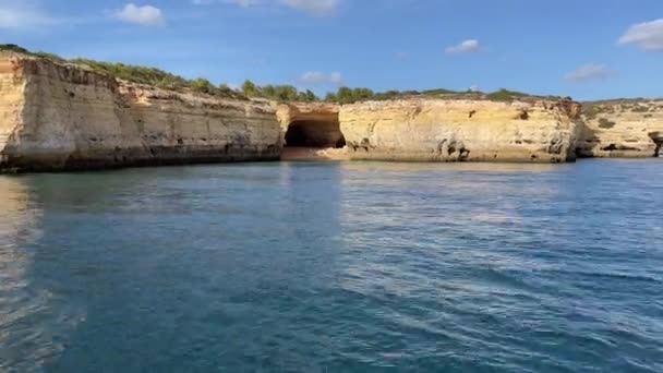 Short Outcrop Sea Cliff Large Sea Cave View Boat Sailing — стоковое видео