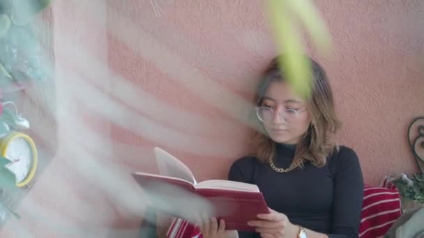 Beautiful Girl Eyeglasses Reading Book Glimpses Her Watch Smiles Medium — Vídeos de Stock