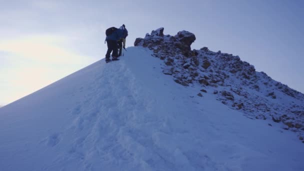 Πεζοπόροι Περπατούν Στο Χιόνι Στην Κορυφή Ενός Χιονισμένου Ηφαιστειακού Βουνού — Αρχείο Βίντεο