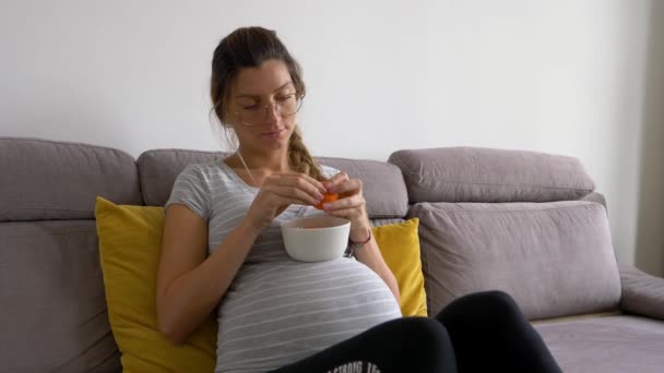 Beautiful Pregnant Woman Glasses Peals Tangerine Eats — 图库视频影像