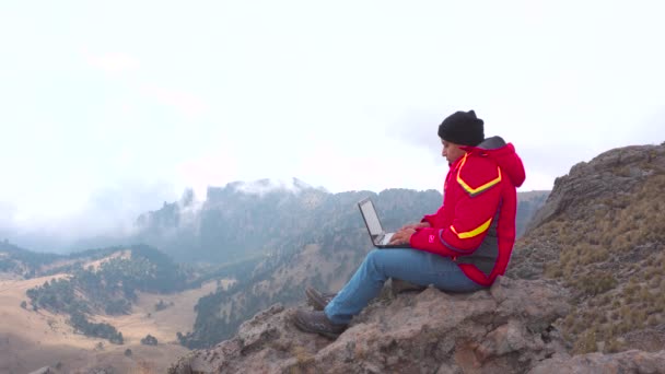 Digital Nomad Young Latin Man Working His Laptop Sitting Rock — стоковое видео