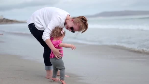 Mother Holds Her Toddler Carefully She Plays Beach Waves Rolling — 图库视频影像
