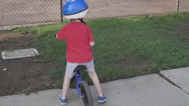 Slow Motion Shot Young Boy Climbing Balance Bike Riding Sidewalk — Stock videók