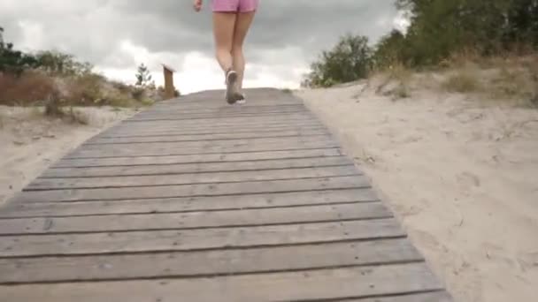 Young Woman Goes Wooden Path Beach Sea Day Windy Cloudy — Vídeos de Stock