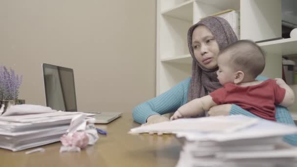 Southeast Asian Muslim Mother Infant Stressing Bills Sitting Desk Stacks — Stockvideo