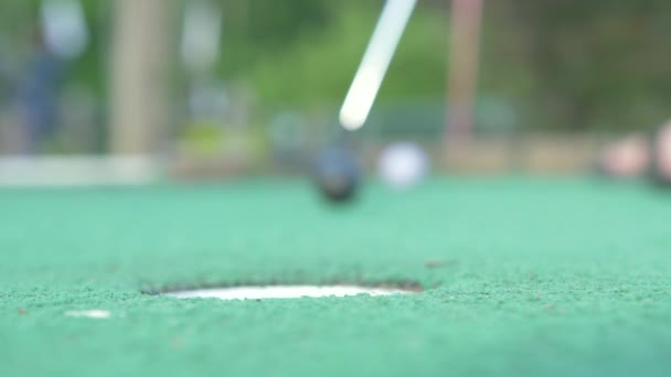 Mini Golf Player Putts Gets Golf Ball Hole Low Angle — Video