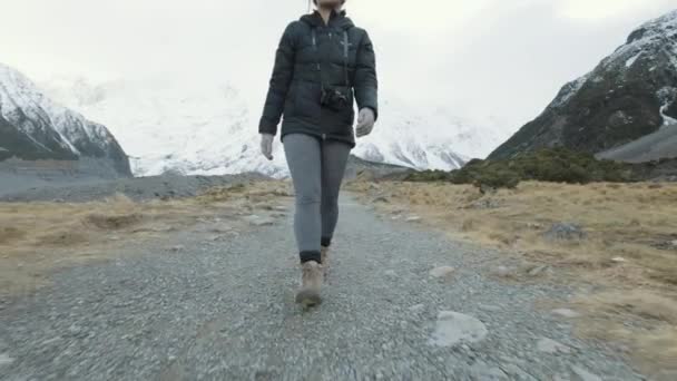 Low High Angle Follow Shot Woman Hiking Snow Capped Mountains — Stockvideo