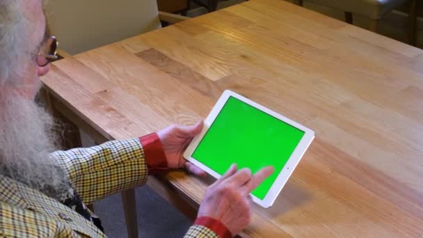 Older Man Beard Watching Tablet Device Swiping Left — Stockvideo