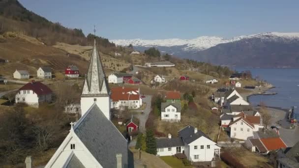 Aerial Shot Orbiting Church Steeple Norwegian Village Snow Capped Mountains — Video