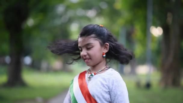 Cute Little Indian Girl Wearing Indian Tricolor Flag Shakes Waves — Stockvideo