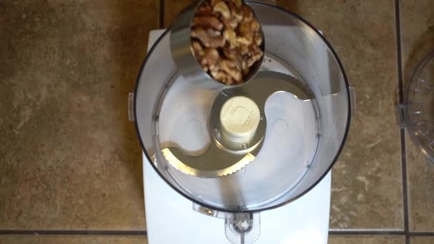 Adding Measuring Cup Walnuts Empty Food Processor Overhead Slowmo — Vídeos de Stock