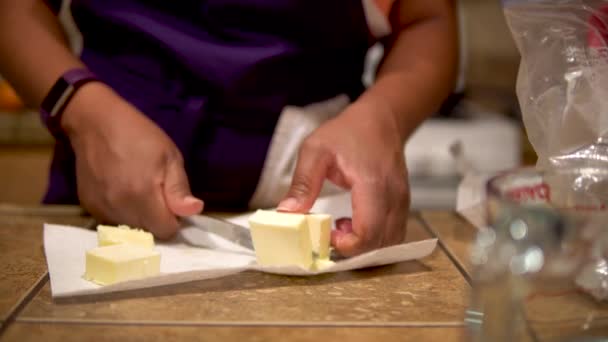 African American Woman Cutting Butter Cubes Close — Stockvideo