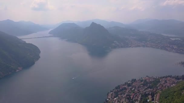 Aerial Drone Shot Forest Large Misty Blue Lake Next Town — Vídeo de Stock