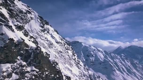 Aerial Drone Shot Dramatic Mountain Cliffs Snow Covered Alps Distance — Vídeos de Stock