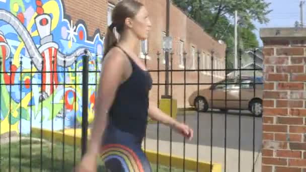 Fit Young Woman Walks Urban Wall Mural City Camera Tracking — 비디오