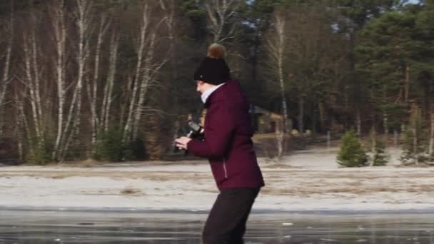 Woman Taking Pictures While Ice Skating — Stockvideo