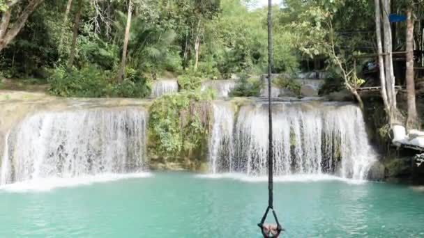 Young Caucasian Man Rope Swinging Letting Falling Turquoise Natural Pool — Stockvideo