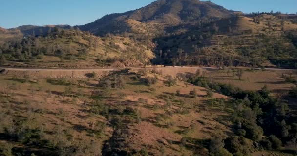 Distant Train Passing Tehachapi California Aerial Side Tracking Pan — Stock video