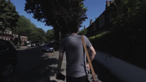 Moving Shot Caucasian Man Wearing Grey Shirt Camera Bag Slung — Stockvideo