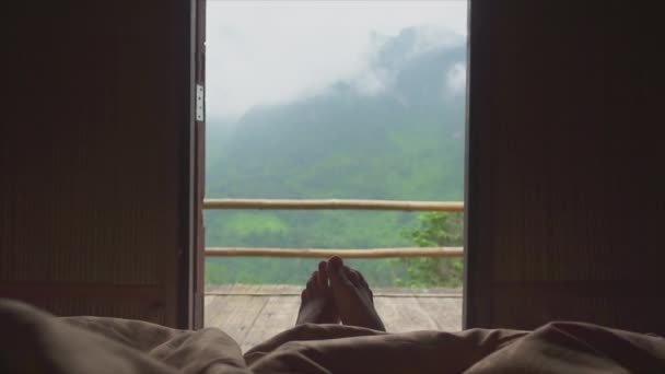 Men Legs Stick Out Blankets Turn Sidesagainst Balcony Mountain Landscape — Vídeo de Stock