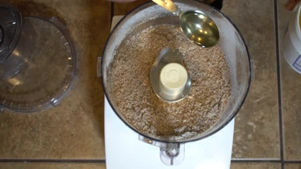 Adding Tablespoon Coconut Oil Dry Ingredients Food Processor Slowmo — Vídeo de Stock