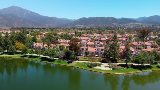 Aerial Drone Rising Community Lake Condos Mountains Background — 图库视频影像