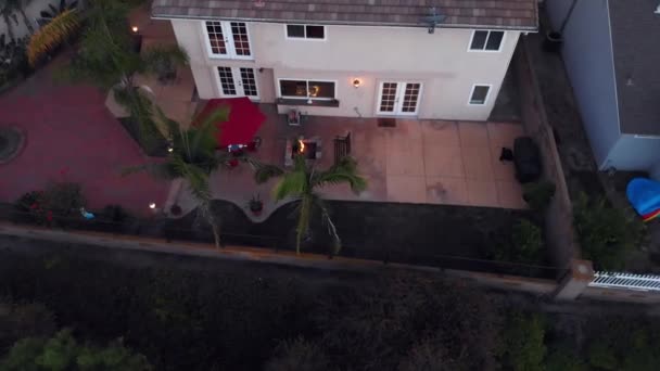 Aerial Rotation Twilight Suburban House Backyard Fire Pit — стоковое видео