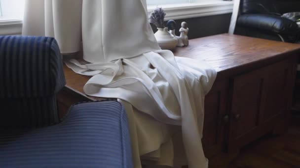 Beautiful White Wedding Dress Draping Wooden Chest — Stockvideo