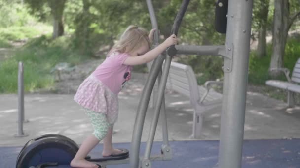 Little Girl Playing Gym Machine Adults Slow Motion — Wideo stockowe