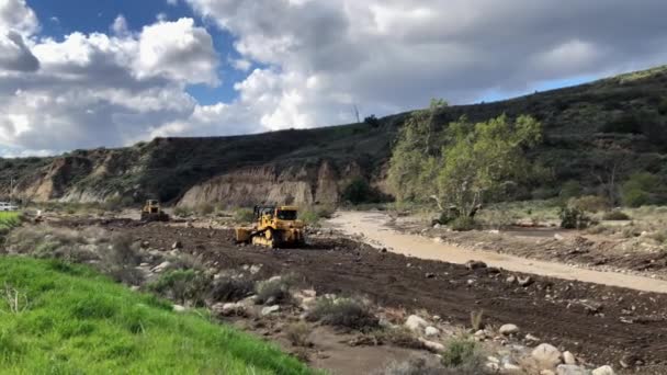 Bulldozers Grading River Bed Storm Washed Out Road Angle — ストック動画