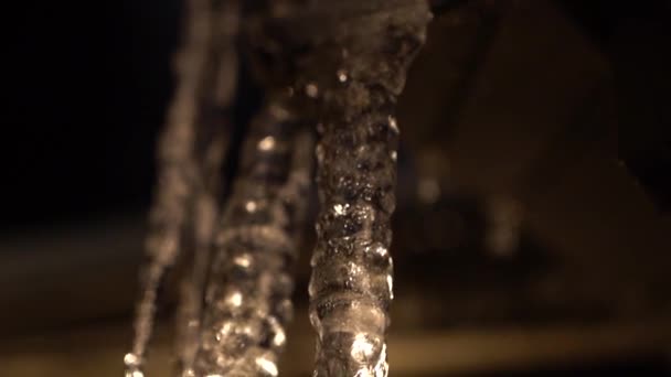 Backlit Melting Icicle Hanging Roof Dripping Slow Motion Shot Panning — Stock video