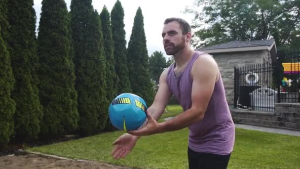 Young Athletic Man Serving Volleyball — kuvapankkivideo