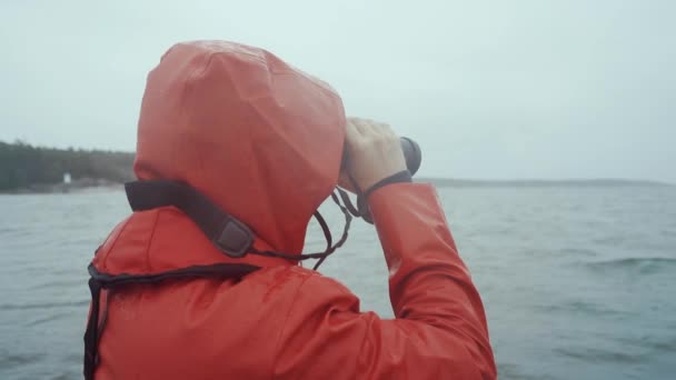 Man Red Raincoat Looking Trough Binoculars Storm — Stockvideo