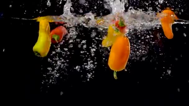 Ζωντανές Γλυκοπιπεριές Που Πέφτουν Στο Νερό Αργή Κίνηση — Αρχείο Βίντεο