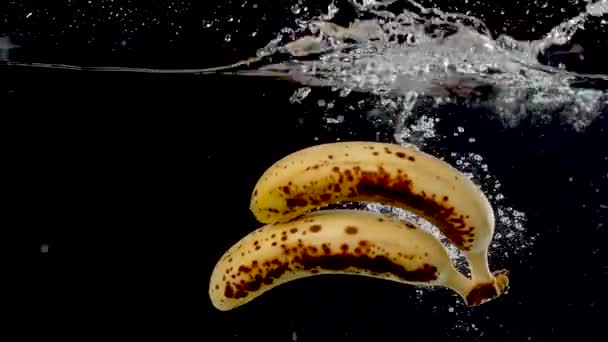 Ripe Bananas Being Dropped Water Slow Motion — Stock video