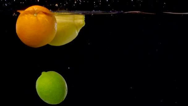 Vibrant Citrus Fruits Floating Water Slow Motion — Stockvideo