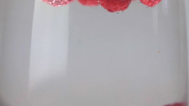 Slow Motion Raspberries Floating Splashing Glass Water Close — Wideo stockowe