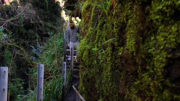 Young Man Slowly Walking Path Carved Side Hill — Stockvideo