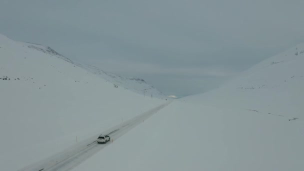 Drone Footage Car Driving Snowy Landscape — Stockvideo