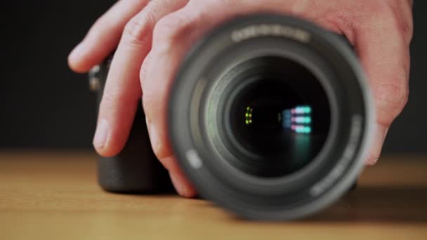 Caucasian Man Hand Zooming Camera Lens Wooden Table — Vídeo de Stock