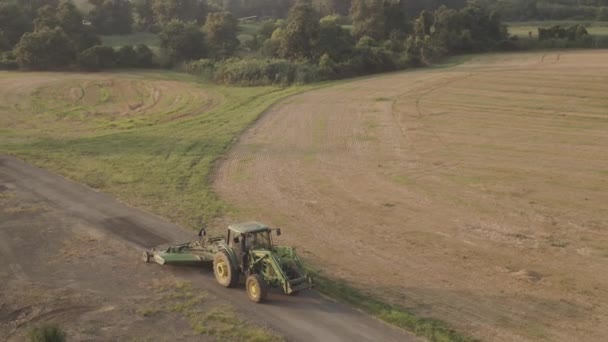 Green Tractor Travelling Farm Road — Stockvideo