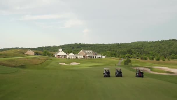 Panning shot of fairway and club house in a golf course