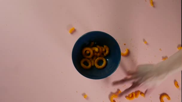 Top View Putting Scattered Cheese Rings Bowl — ストック動画